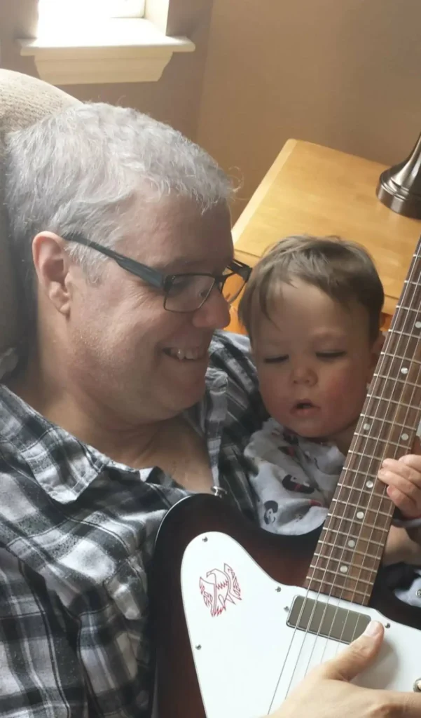 Rob gives Dylan his first guitar lesson (he's far to young)